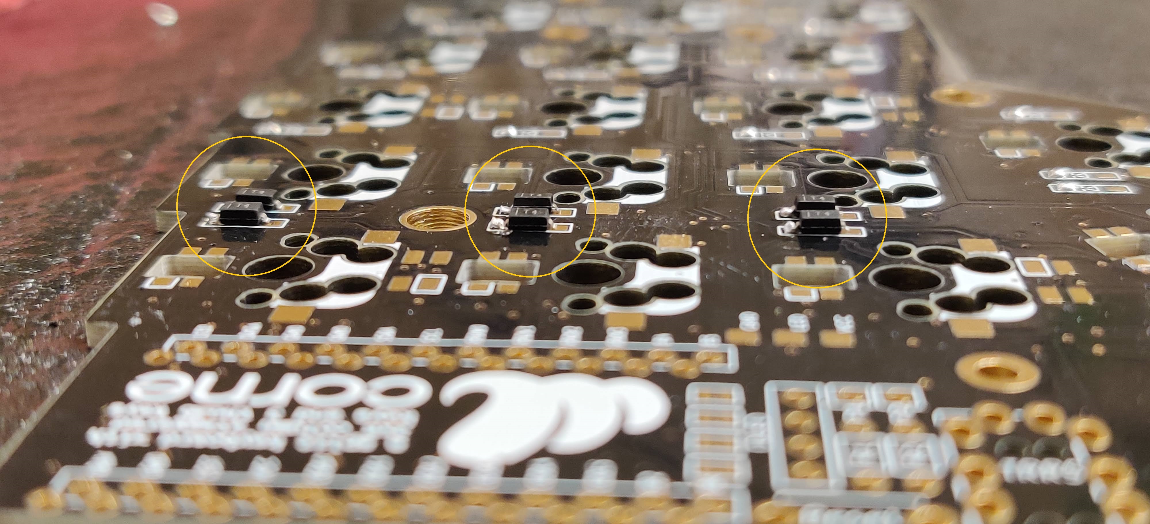 A view of six diodes that are halfway soldered to the board